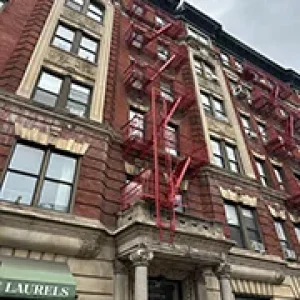 Fire Escape Repair Services for NYC Property Owners 4 Emergency fire escape repair NYC – red fire escape on historic apartment building
